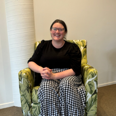 Melissa on her first day sitting in a green chair at the Volunteer Centre